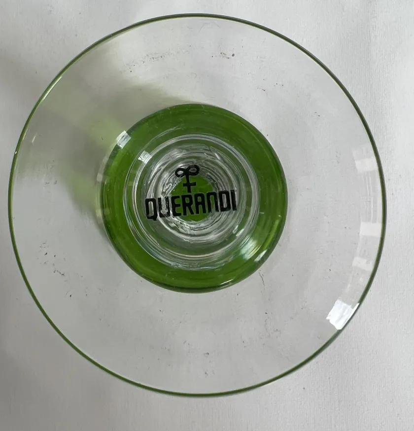 Top view of 12 antique glasses querandi with green base and logo