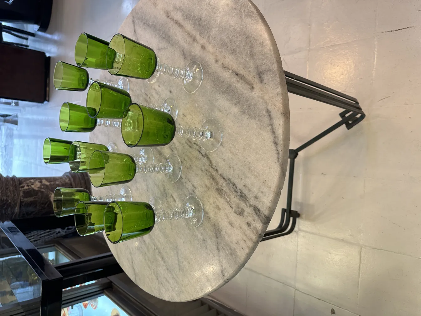 Set of 12 green antiquities glasses Querandi, displayed in a neutral setting.