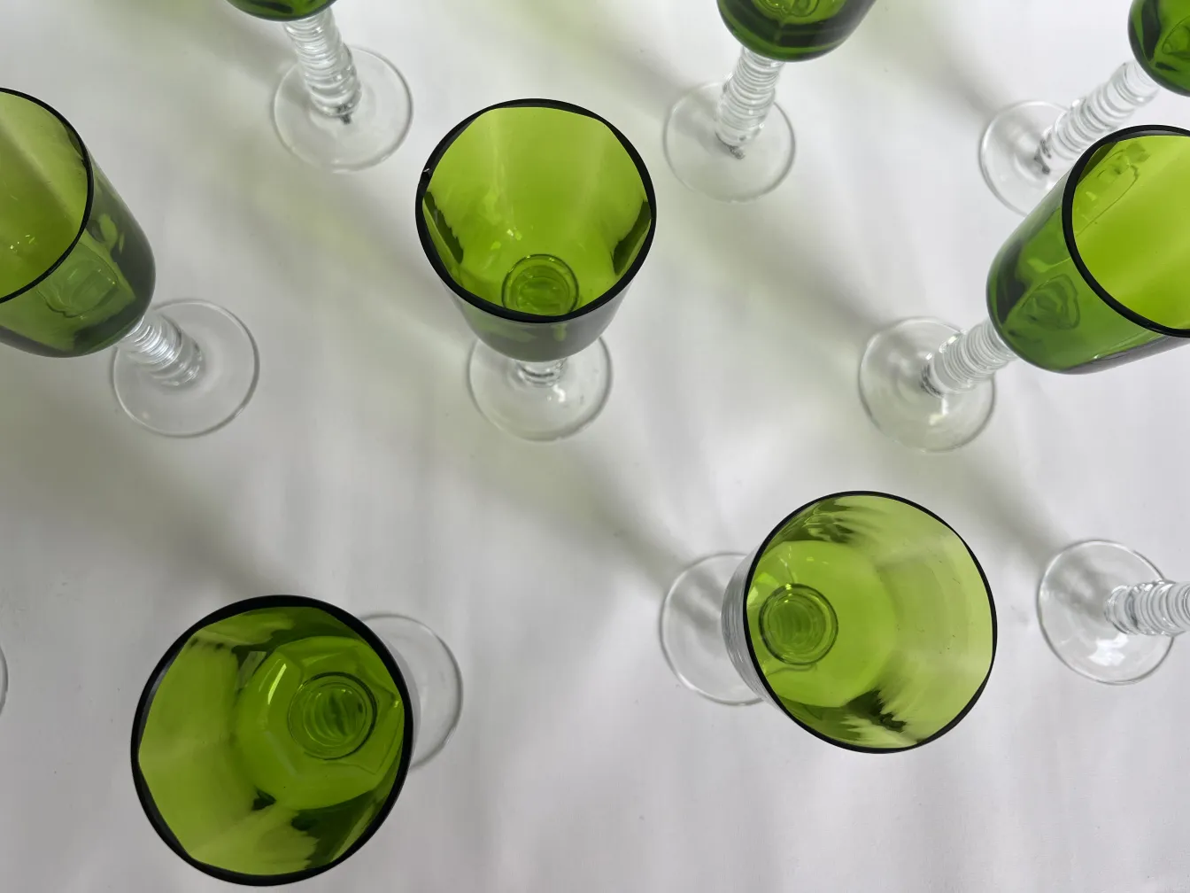 Top view of 12 Querandi glasses in green tones.