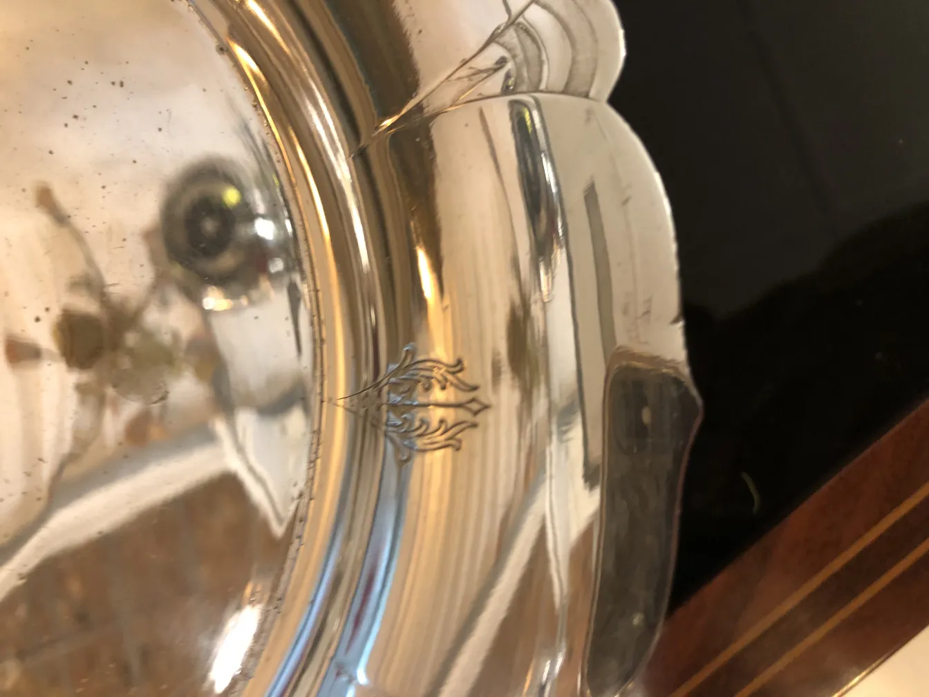 Antique pastry plate with intricate design and surrounding ambiance.