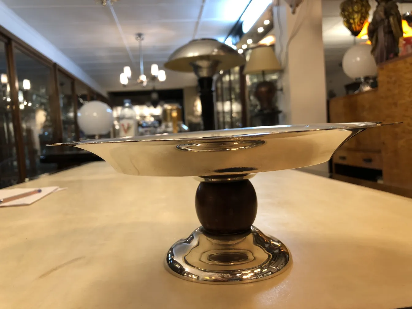 antique pastry plate with elegant design, on a pedestal, in a cozy setting