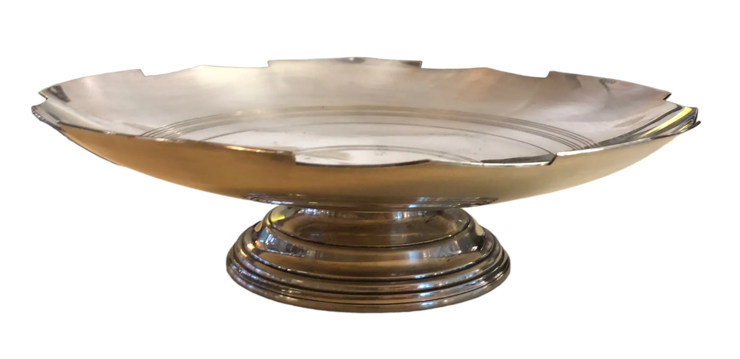 Antique pastry plate with elegant base and wavy design.