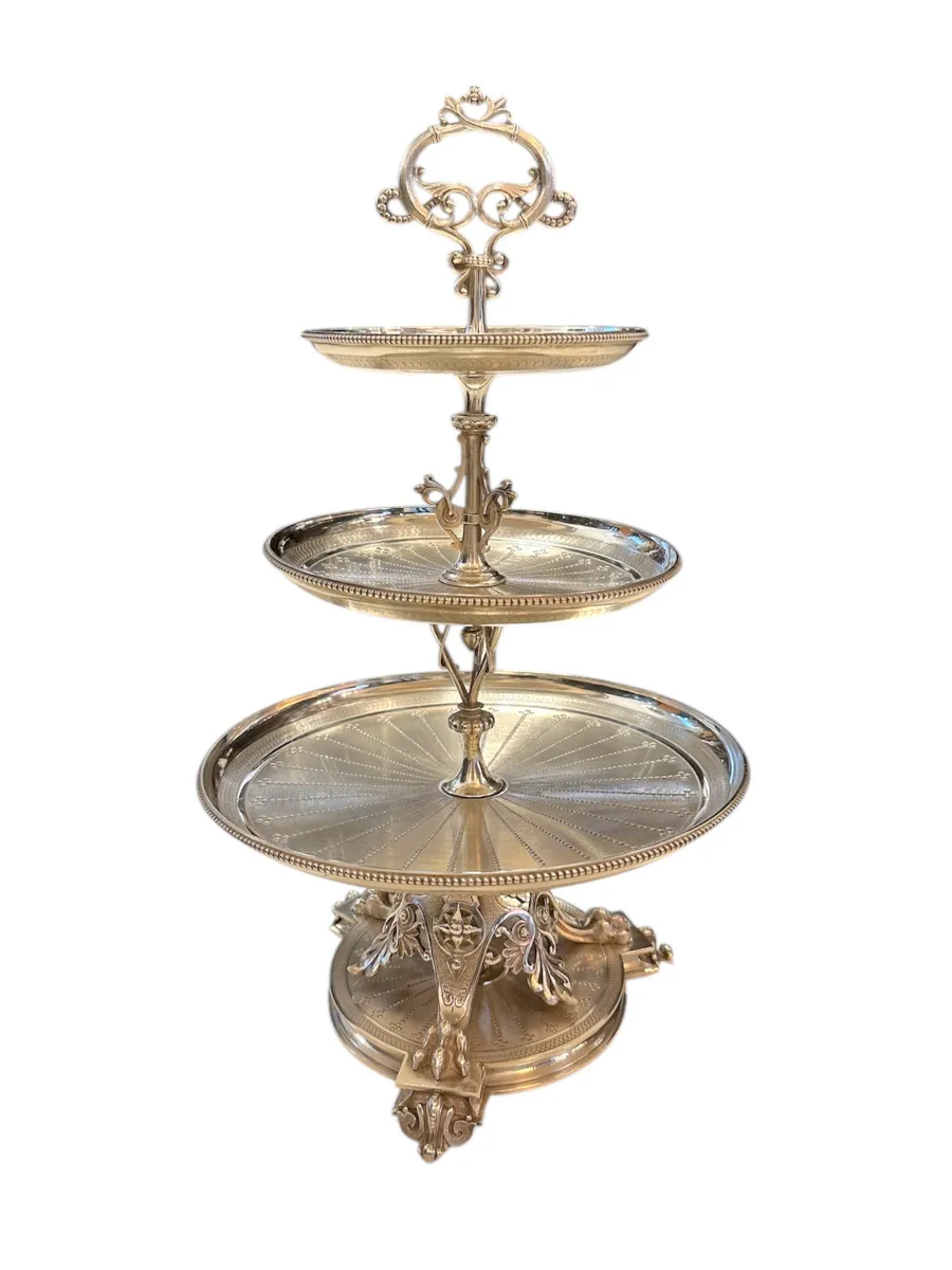 Antique pastry plate with three tiers and ornate design.