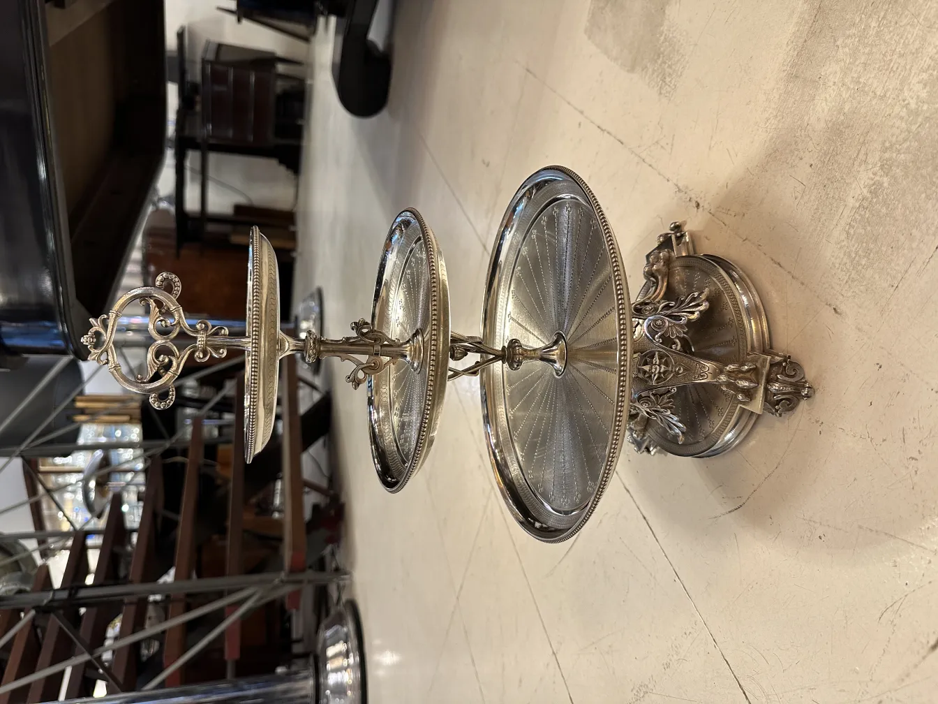 Antique pastry plate with two tiers and decorative details. Elegant setting.