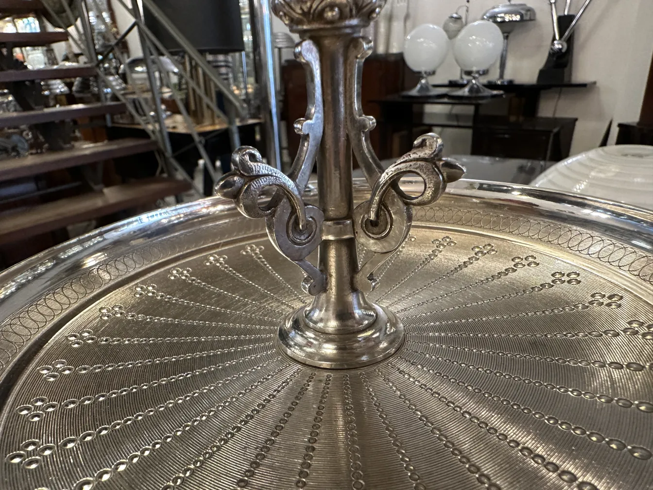 Piatto da dolci antico con design elaborato, circondato da decorazioni vintage.