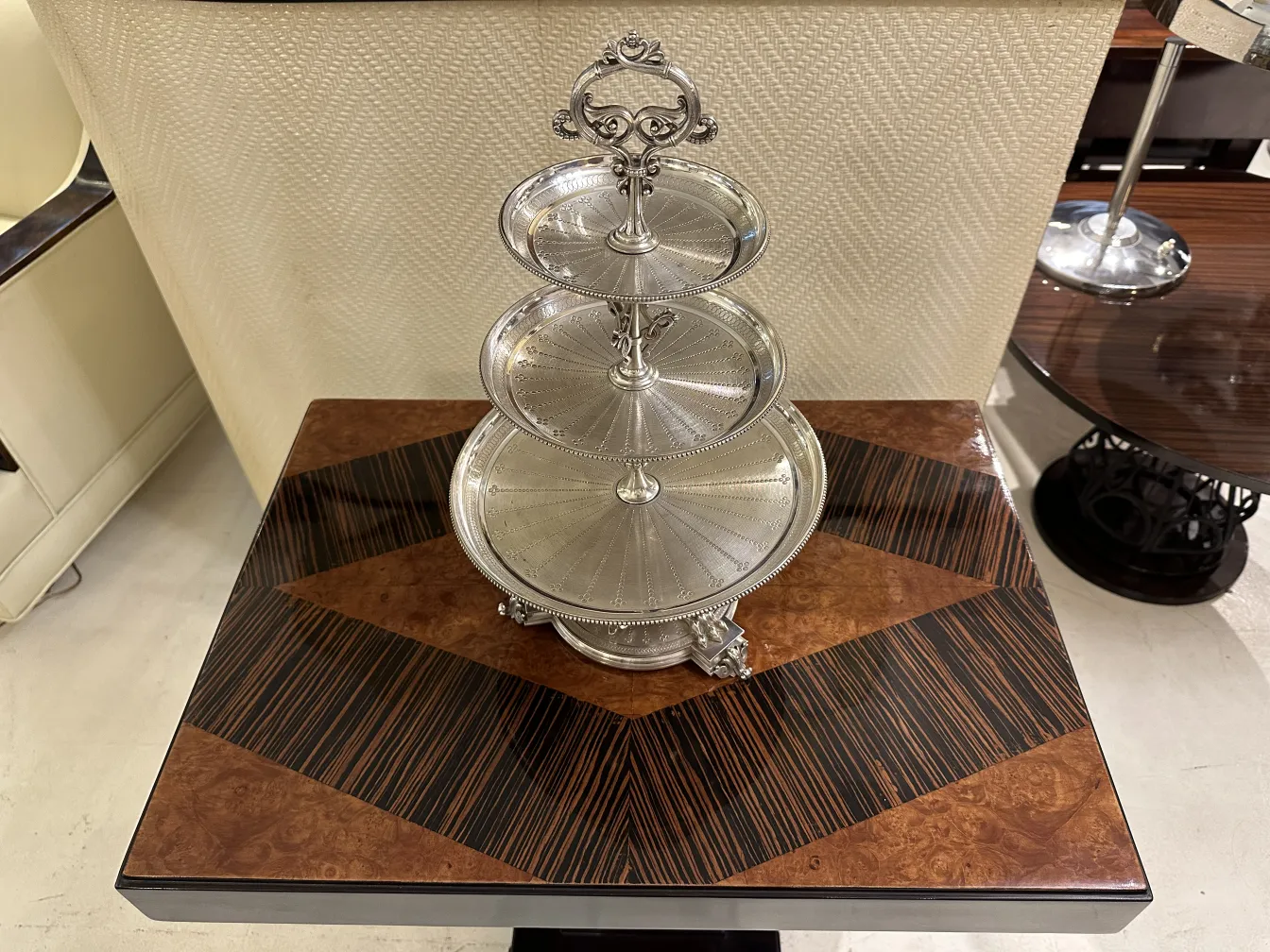 Antique pastry plate with multiple tiers in an elegant setting.