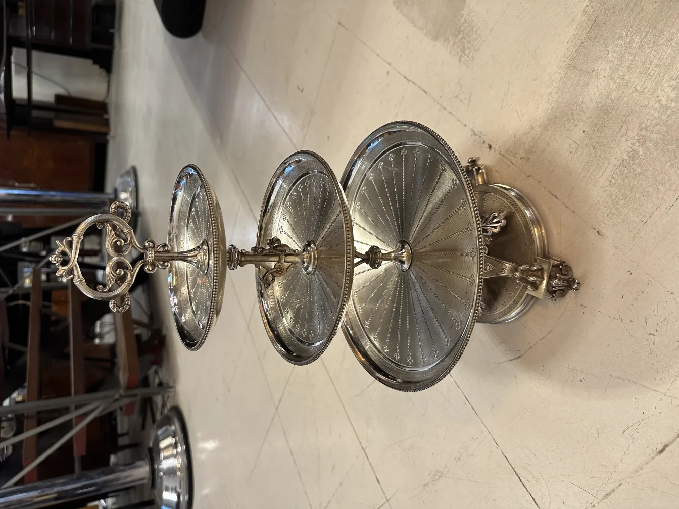 Antique pastry plate with three tiers and decorative handle.