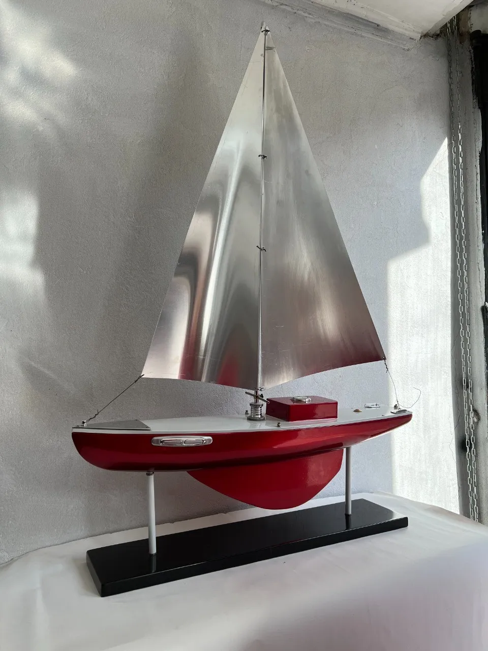 Modelo de um antigo barco do designer em vermelho com velas