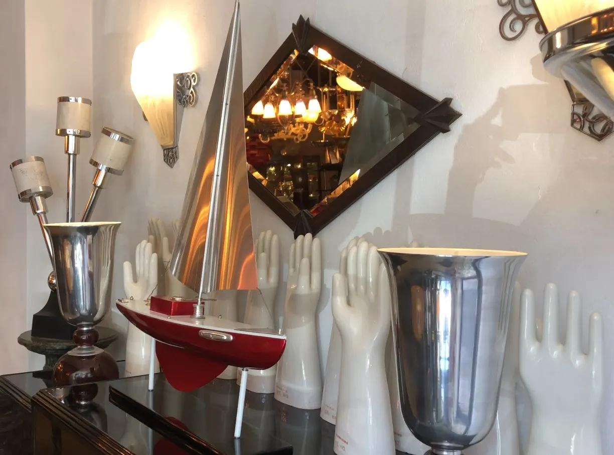 Antique designer's ship by Marcelo Peña in a decorative setting with lights and various objects.