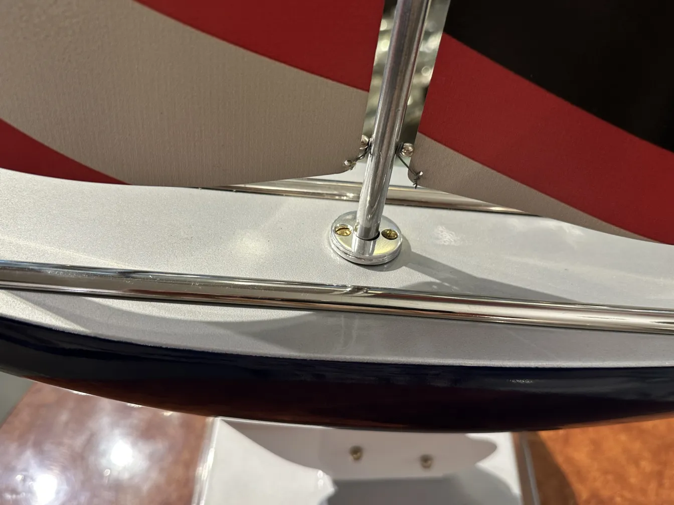 Antique model ship with red and white sails, designed by Marcelo Peña.