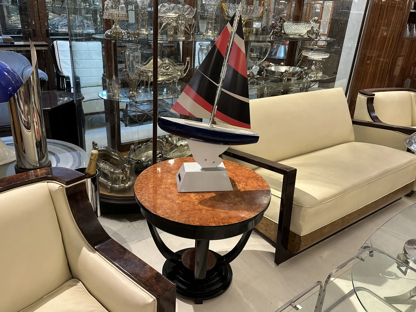 Antique designer's ship with colorful sails in living room.