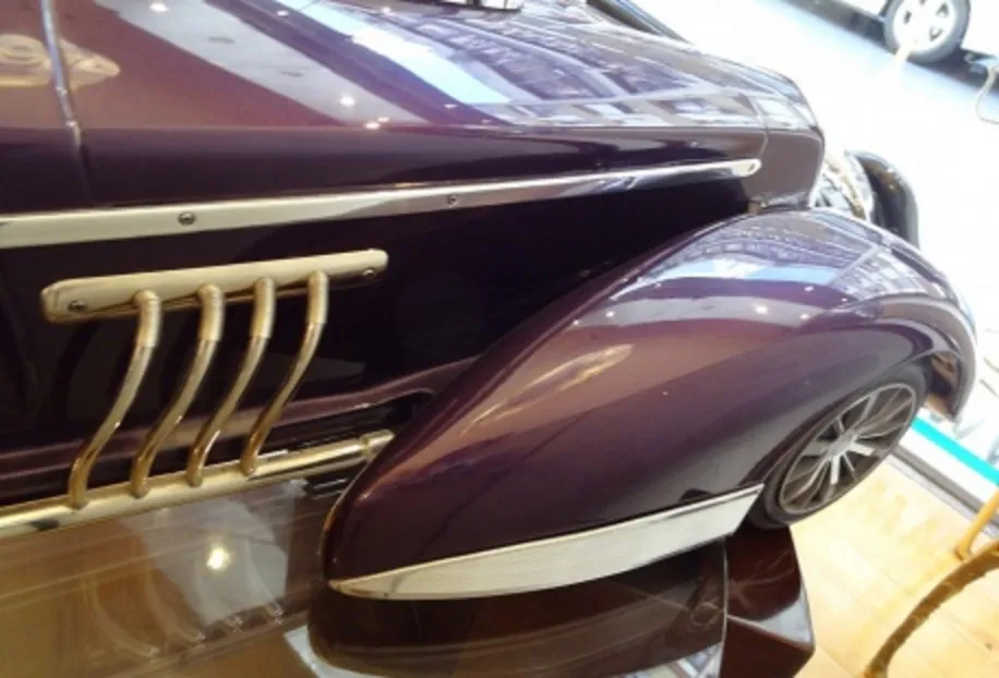 Antique car by designer Marcelo Peña, bright purple color.