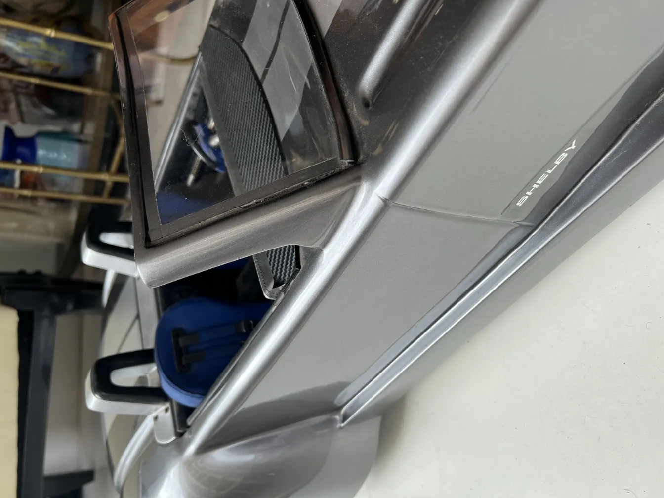 Side view of an antique car by designer Marcelo Peña in a casual setting.