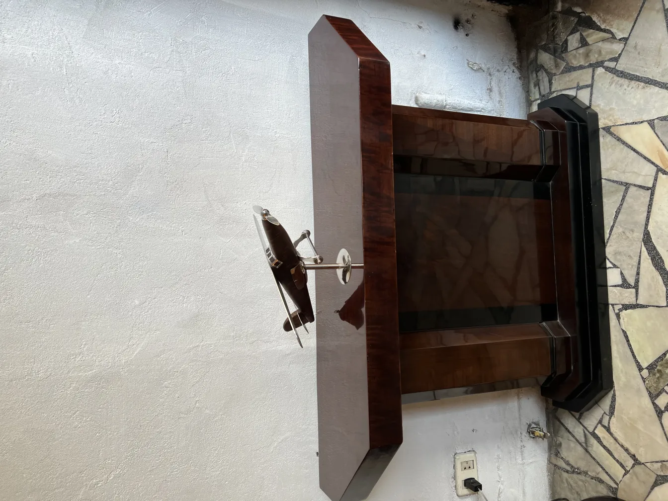Sculpture of antique aircraft by designer Marcelo Peña on an elegant table.
