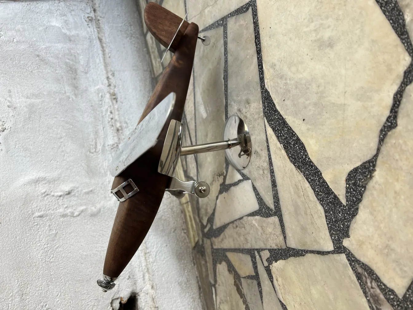 Antique aircraft model by Marcelo Peña with wall details.