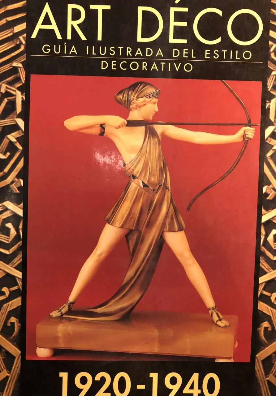 antique sculpture of woman with bow and arrow, on red background