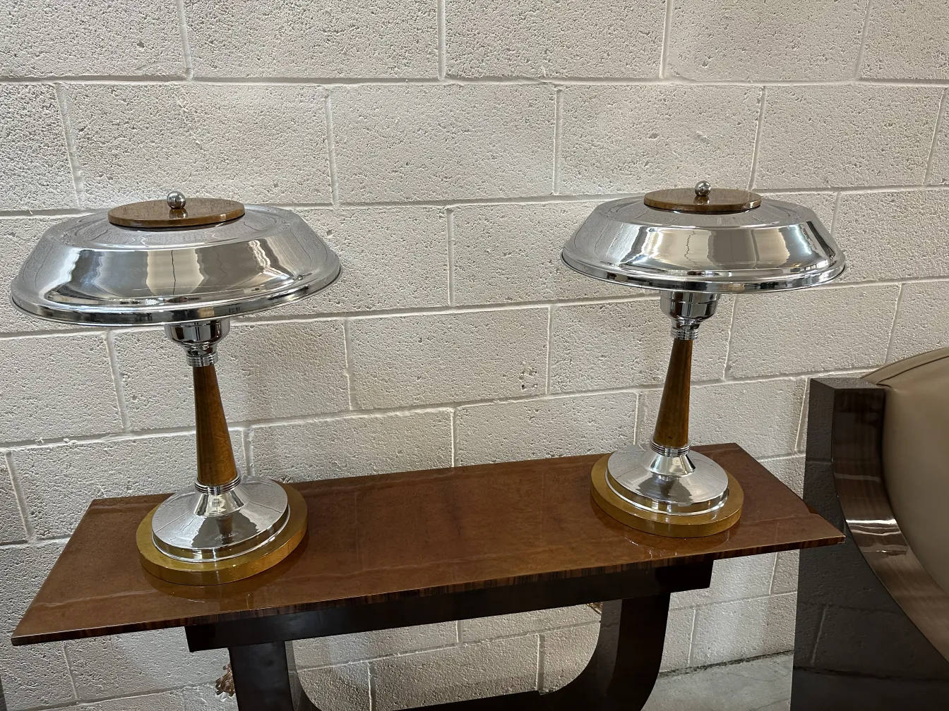 antique console with lamps on a dark table