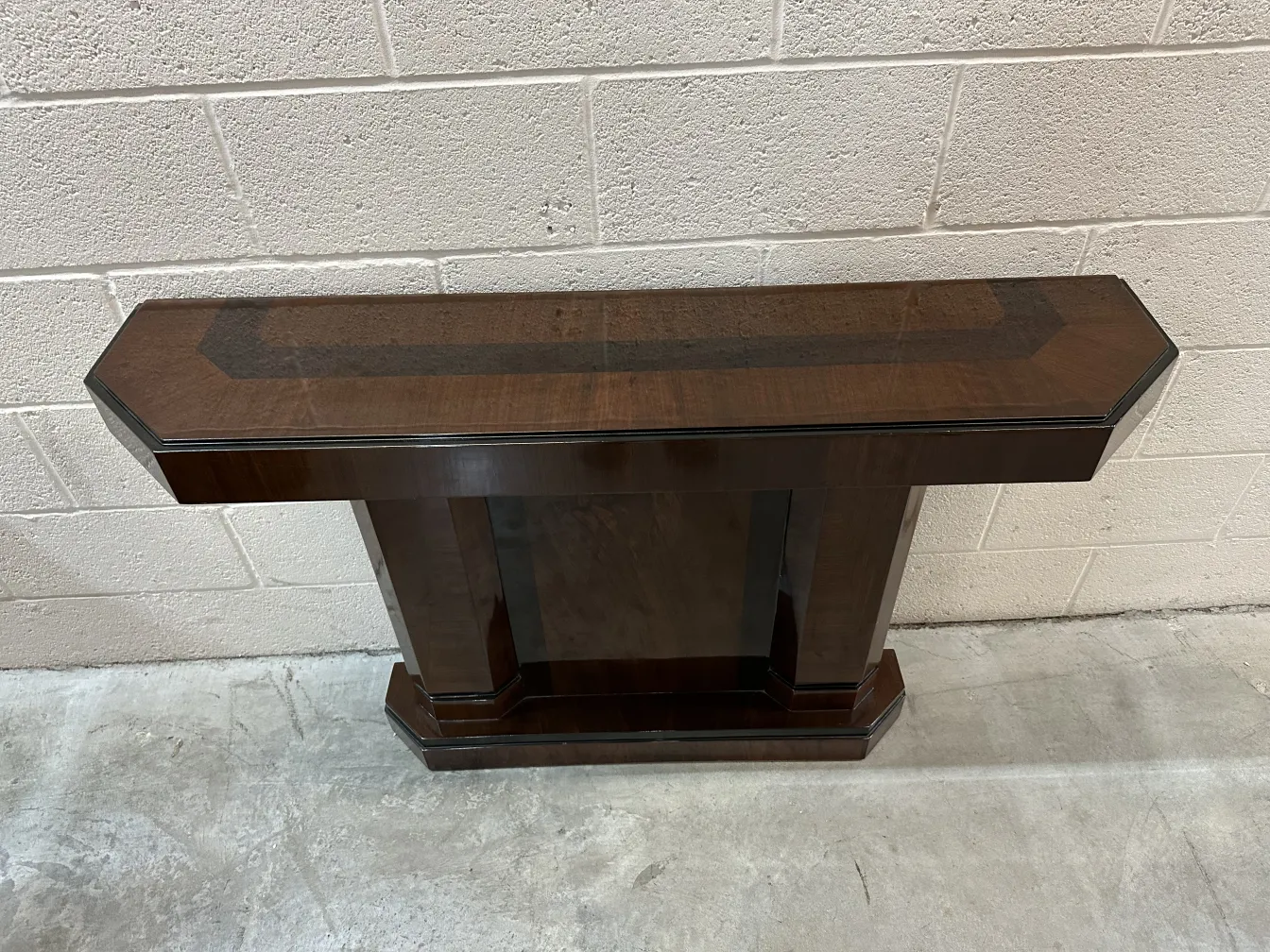 two antique consoles with a classic design in a simple setting