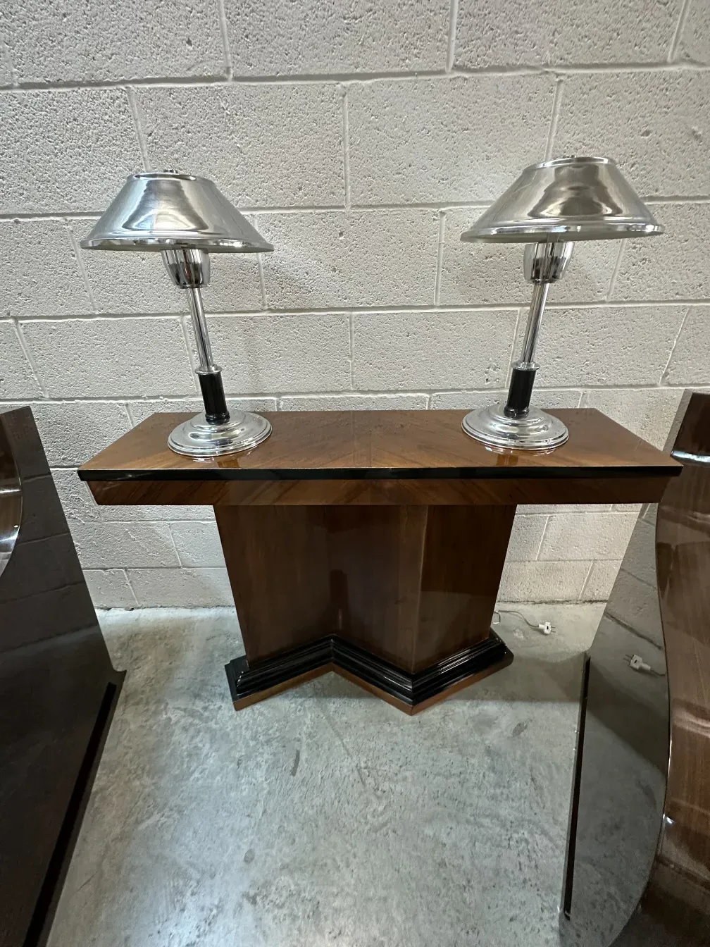 Pair of antique consoles with elegant lighting, surrounded by a sophisticated environment.