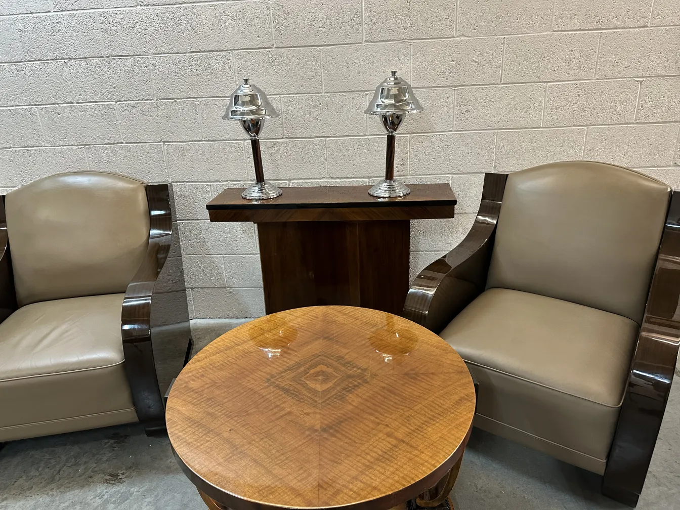 two antique consoles in an elegant setting with lamps