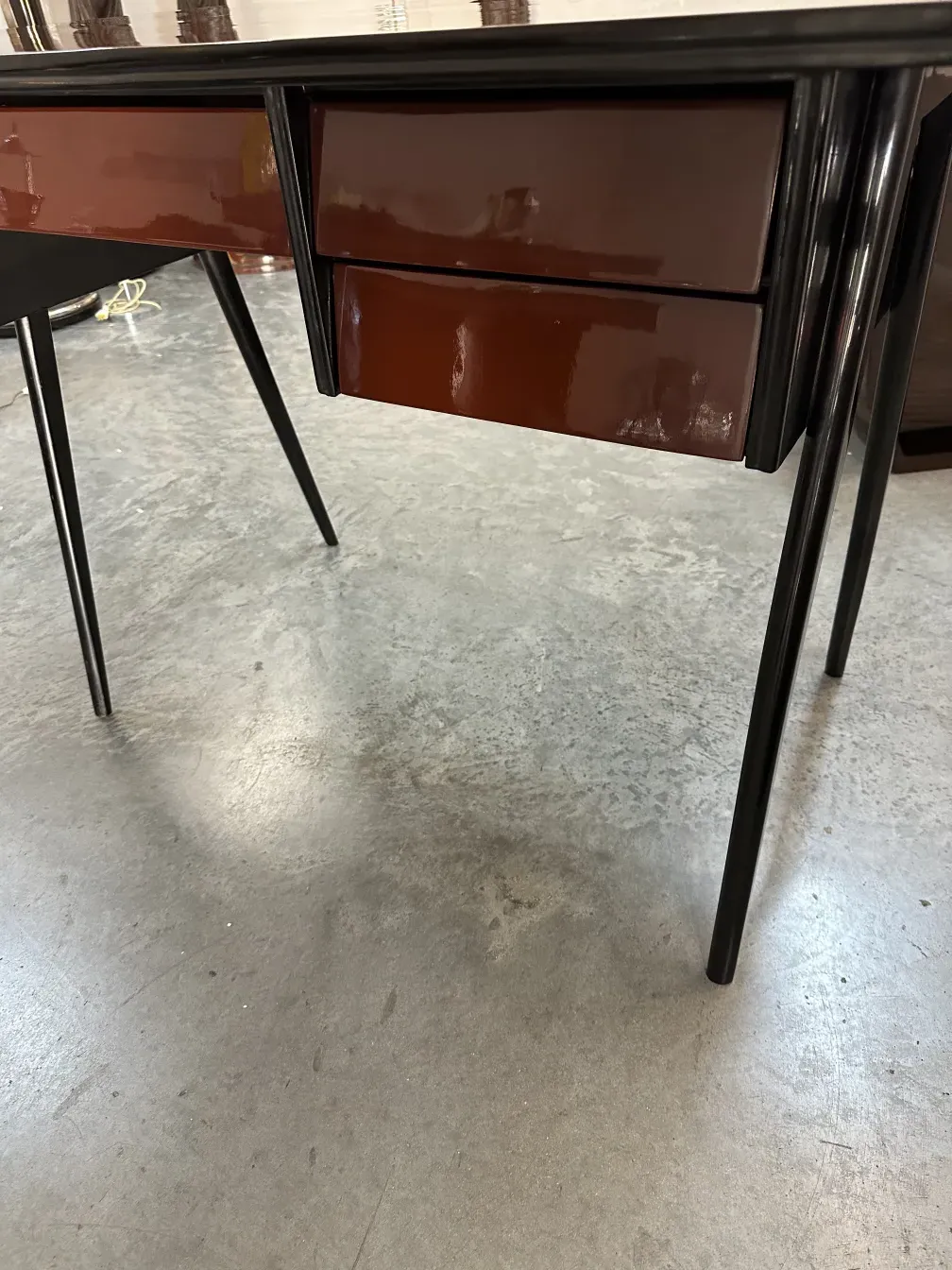 antique desk with two drawers and black legs