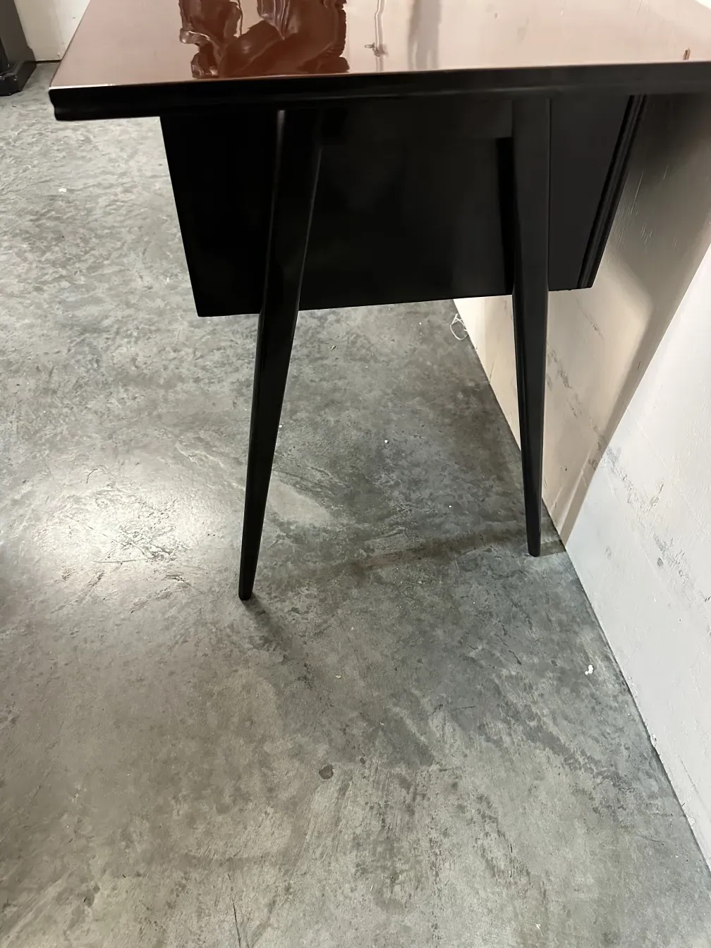 bureau ancien avec pieds fins sur sol gris