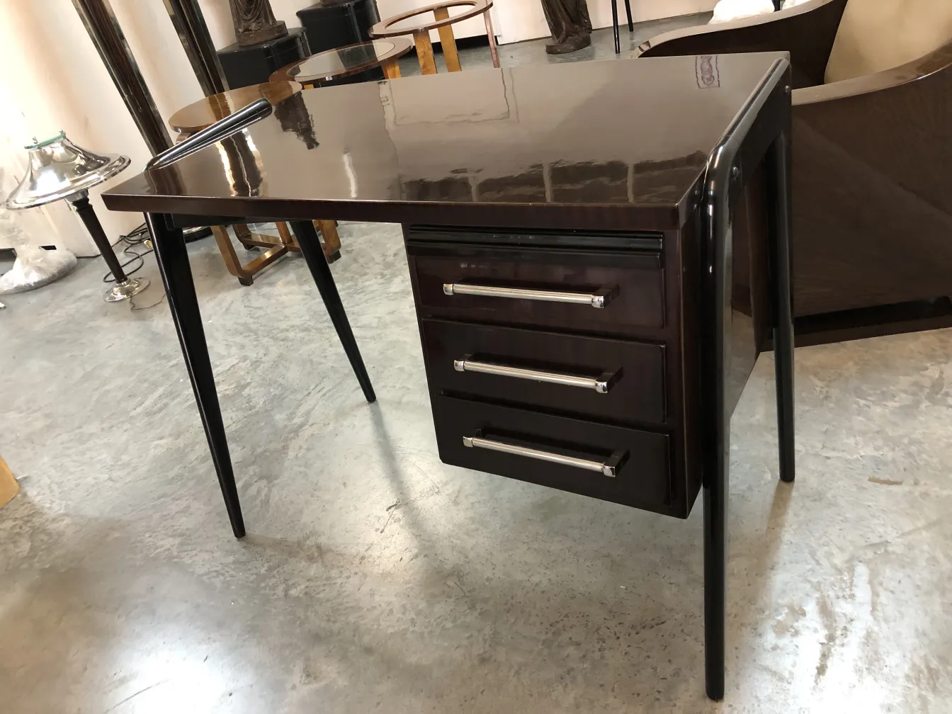 antique desk featuring three drawers and slender legs