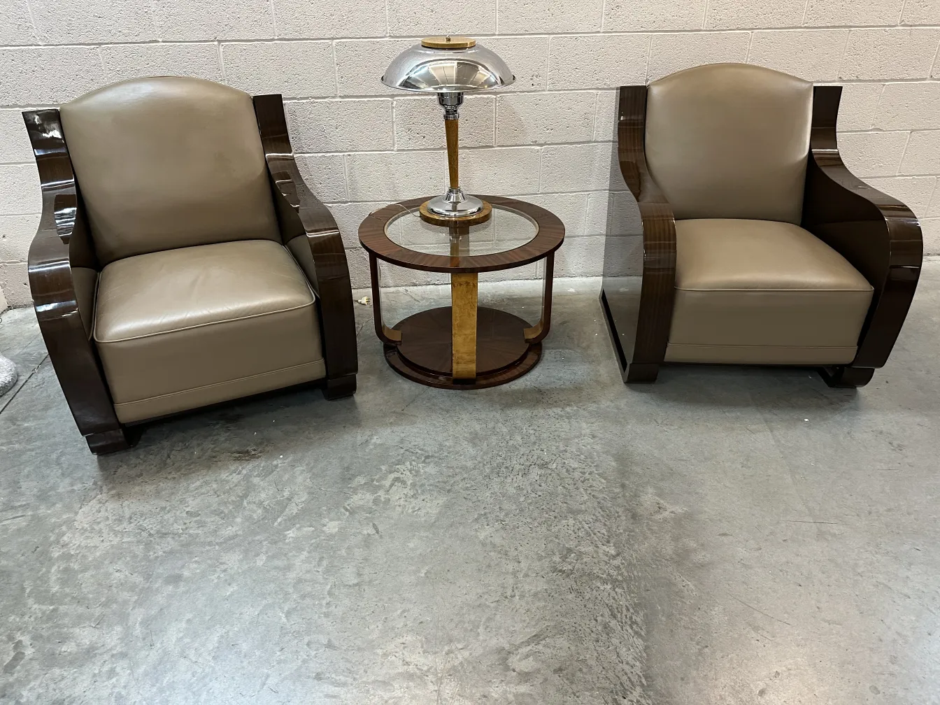 Two antique table lamps with elegant design next to armchairs