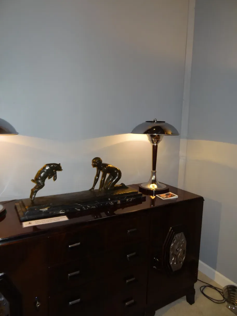 two antique table lamps with a metal base and warm light, set in a cozy environment