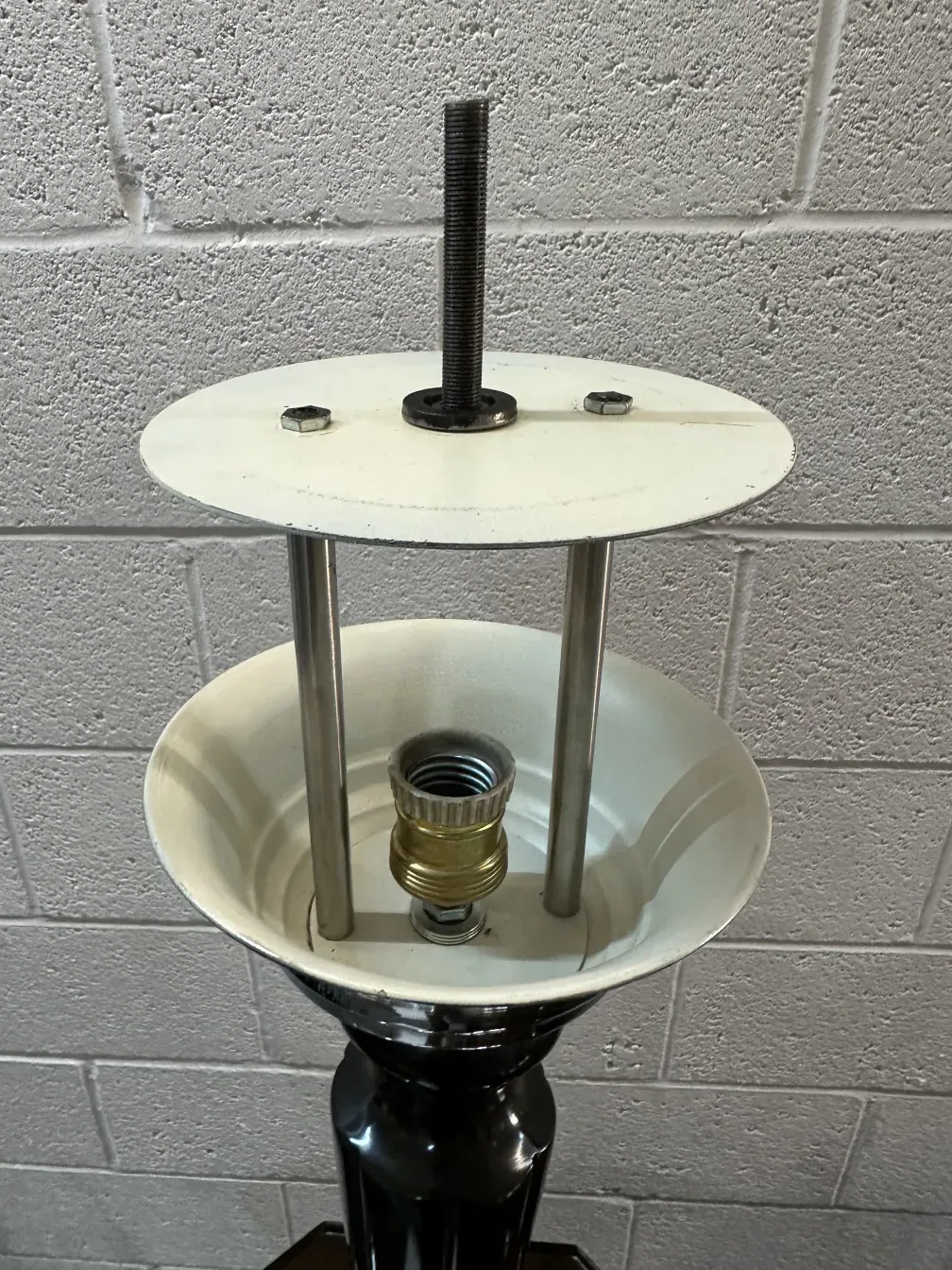 View of two antique table lamps with visible structures in a simple setting.