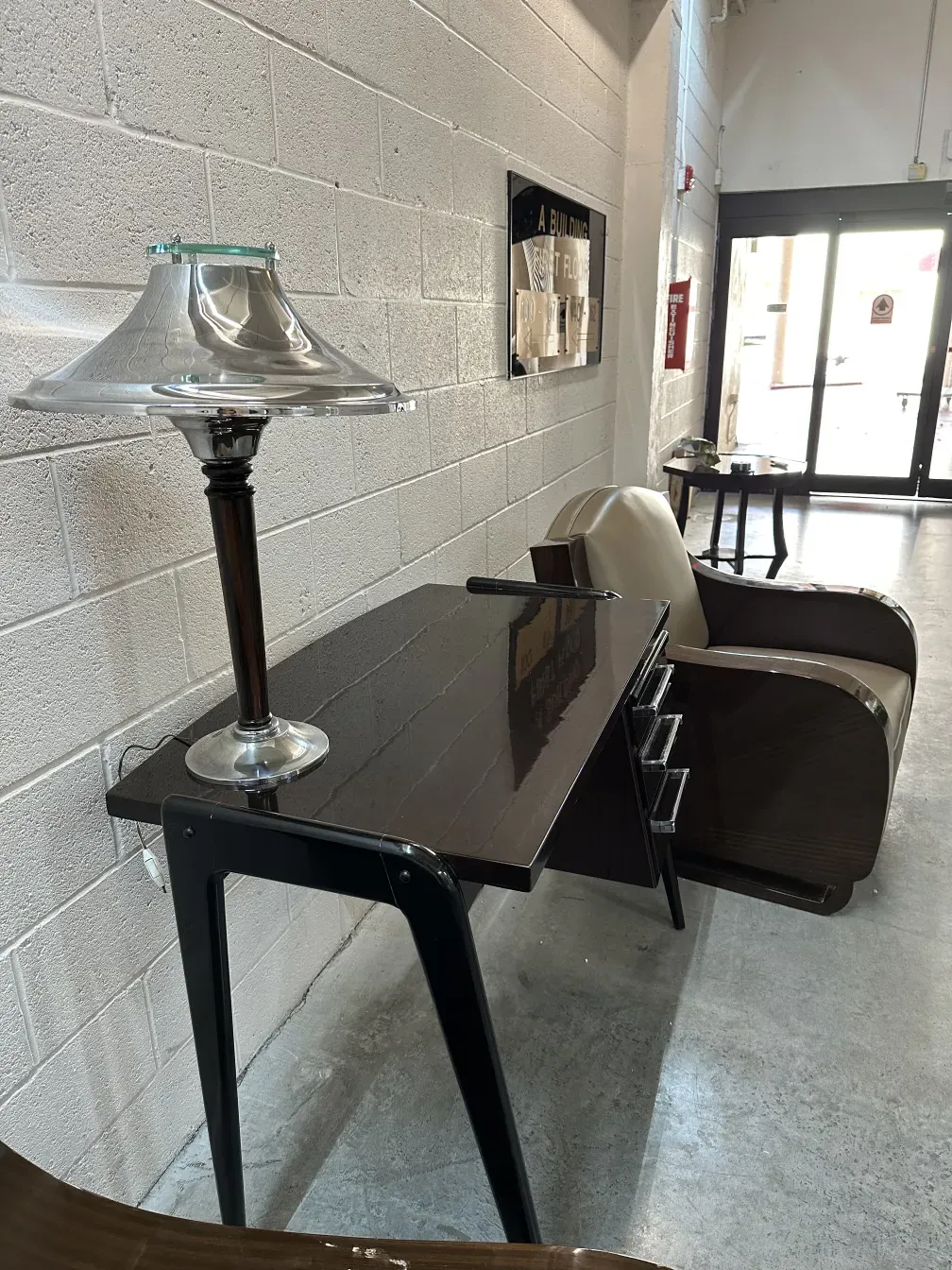 Antique table lamp with decorative base and shiny shade in a modern setting.