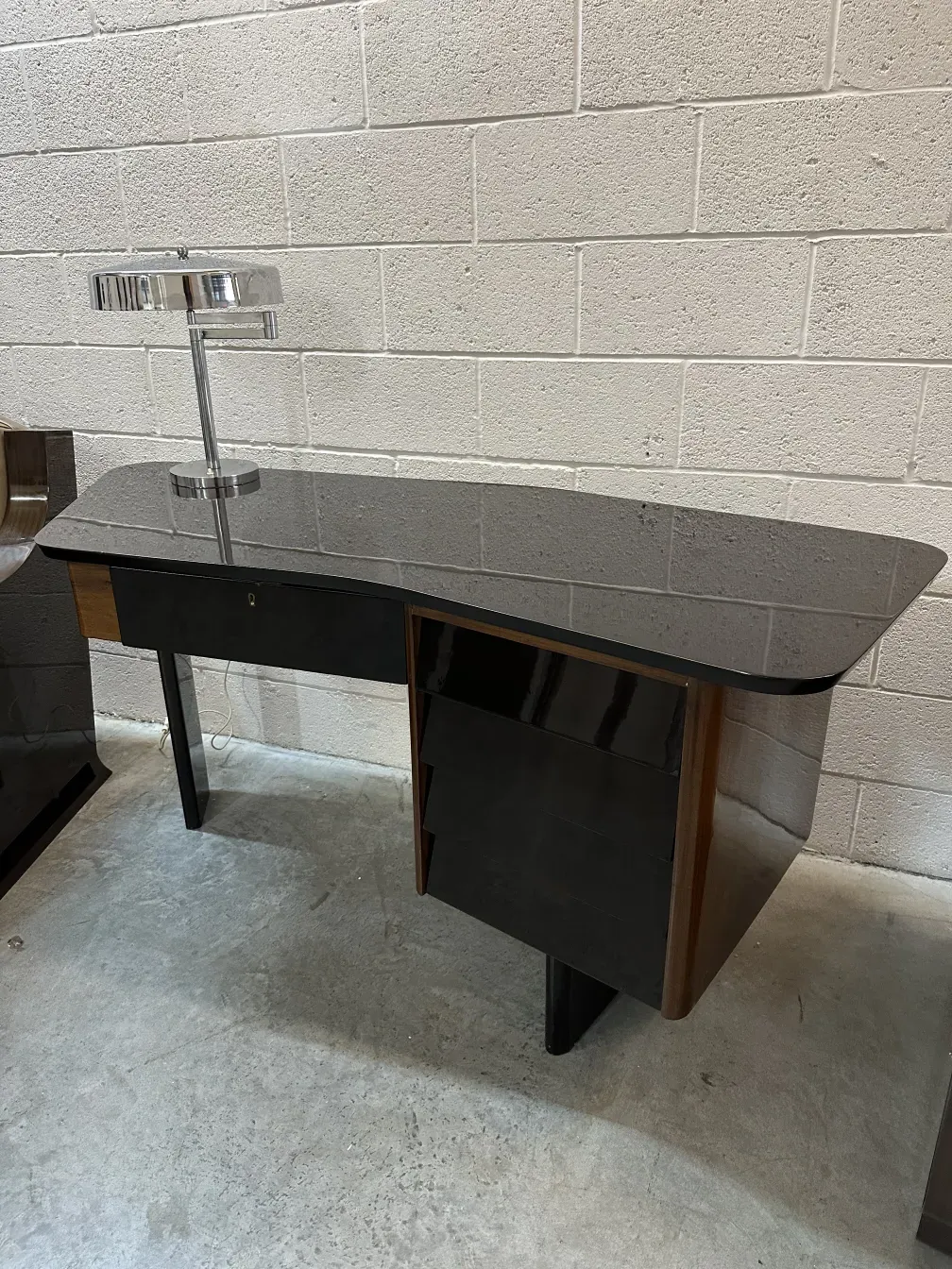Lámpara de mesa antigua con base negra, ambiente moderno.