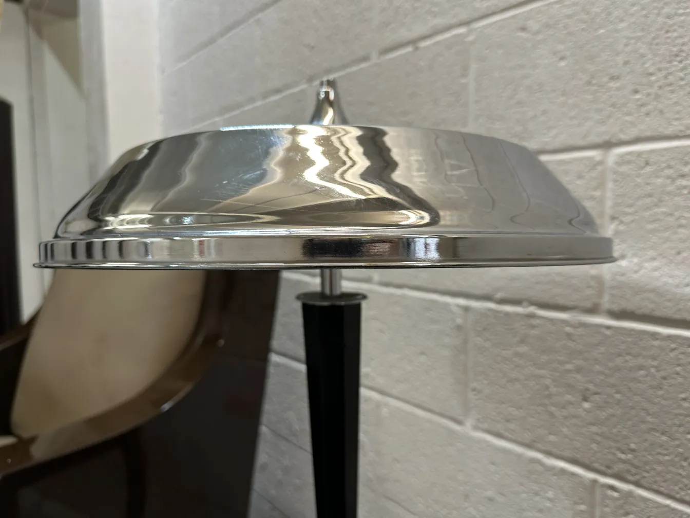 Antique table lamp with shiny shade in a classic environment.