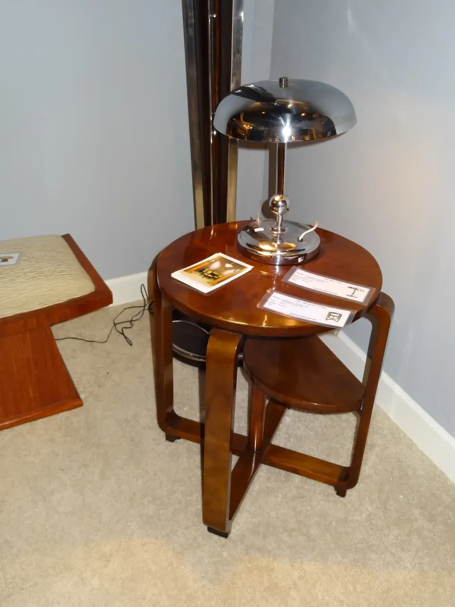 Luminária de mesa antiga com base brilhante, decorativa, em ambiente acolhedor.