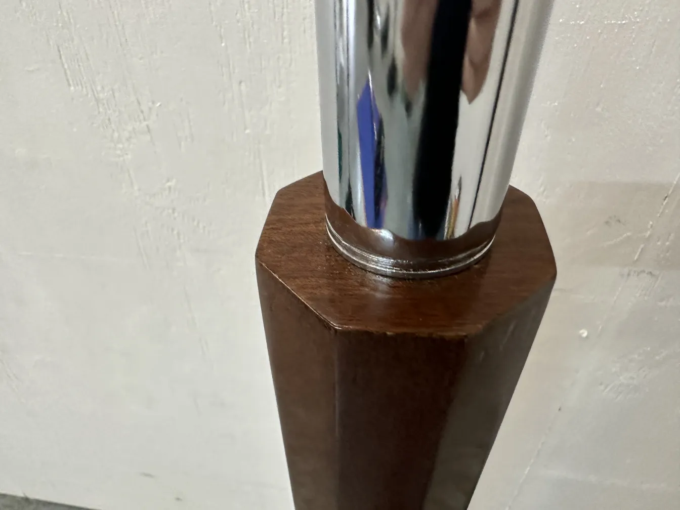 Image of two antique floor lamps in a simple setting.