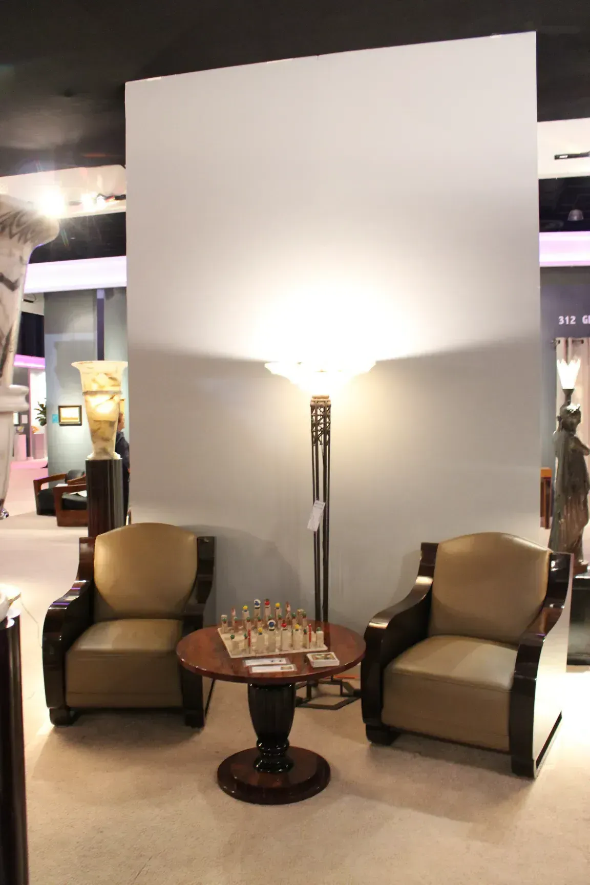 Two antique floor lamps in a cozy room with chairs