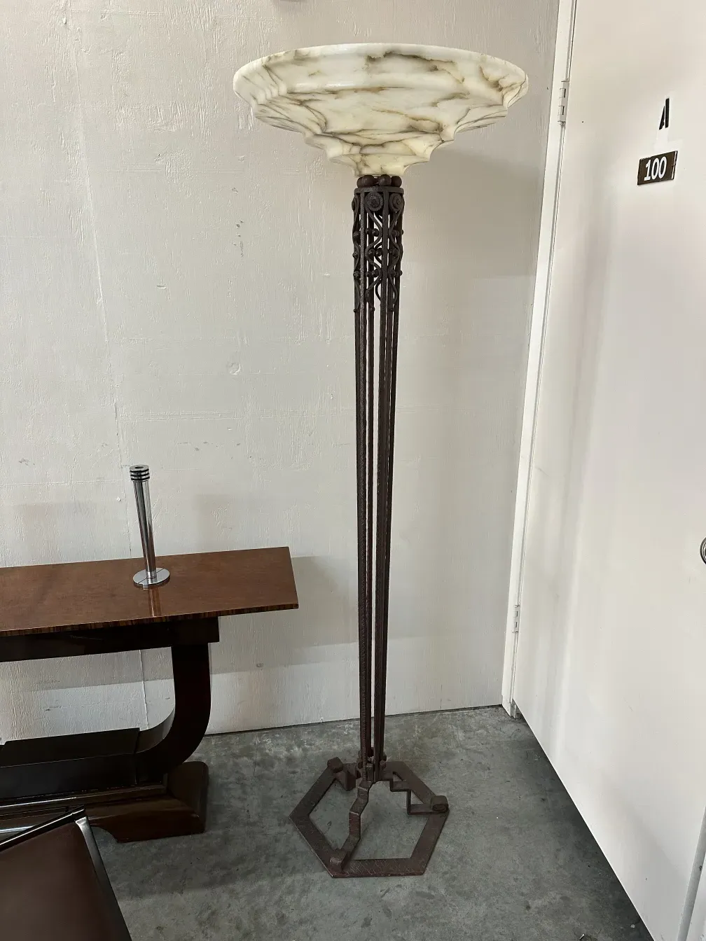 Two antique floor lamps with decorative base in neutral setting