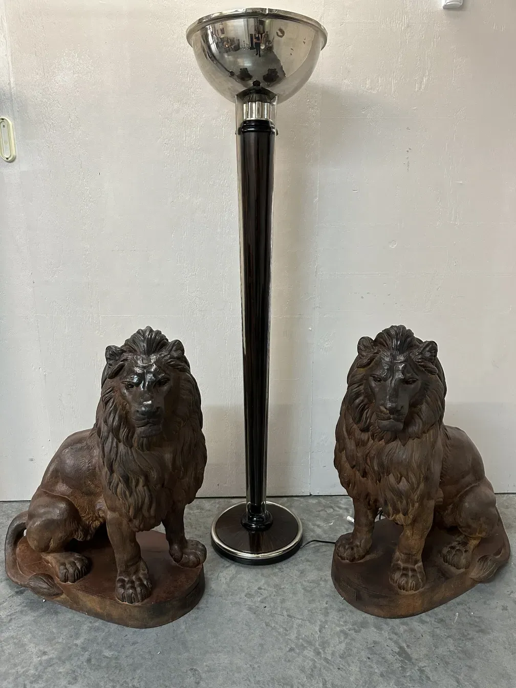 2 antique floor lamps beside decorative lions