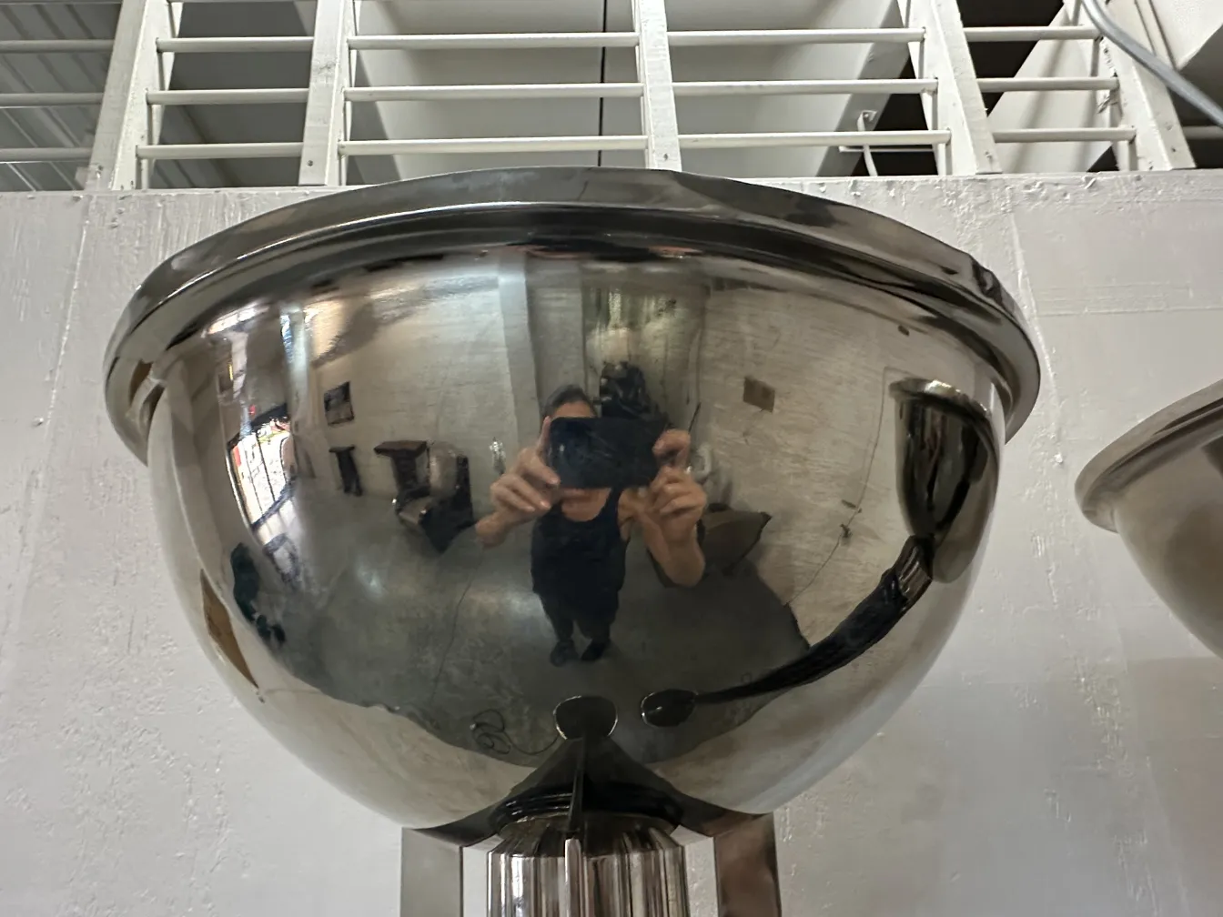 Blick auf zwei antike Stehleuchten in einer gut beleuchteten Umgebung, die die Umgebung reflektieren.