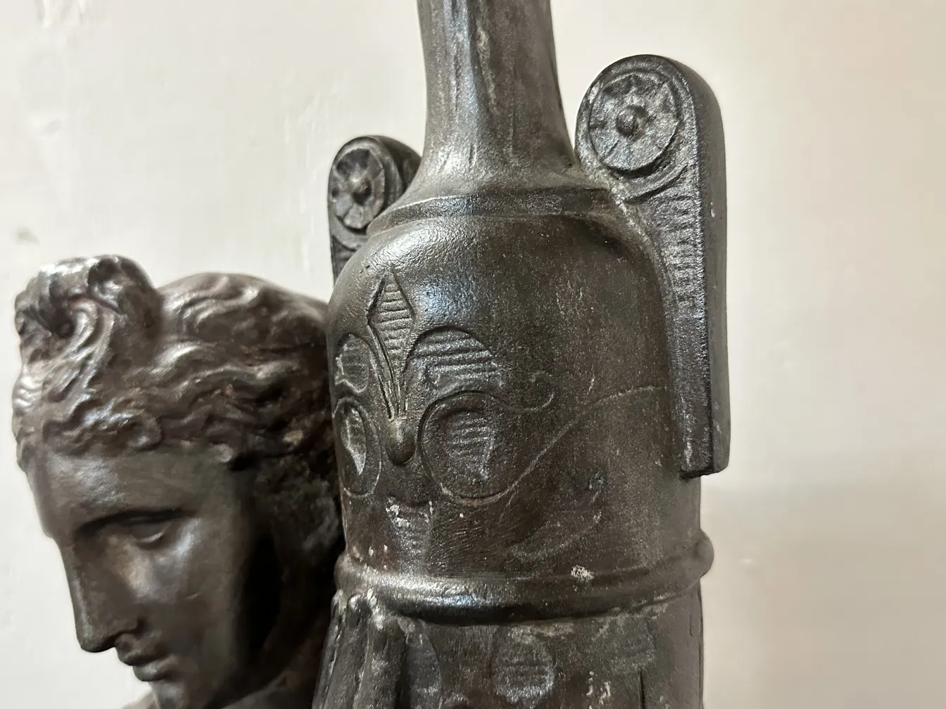 Two antique floor lamps with clear decorative details in a classic setting.