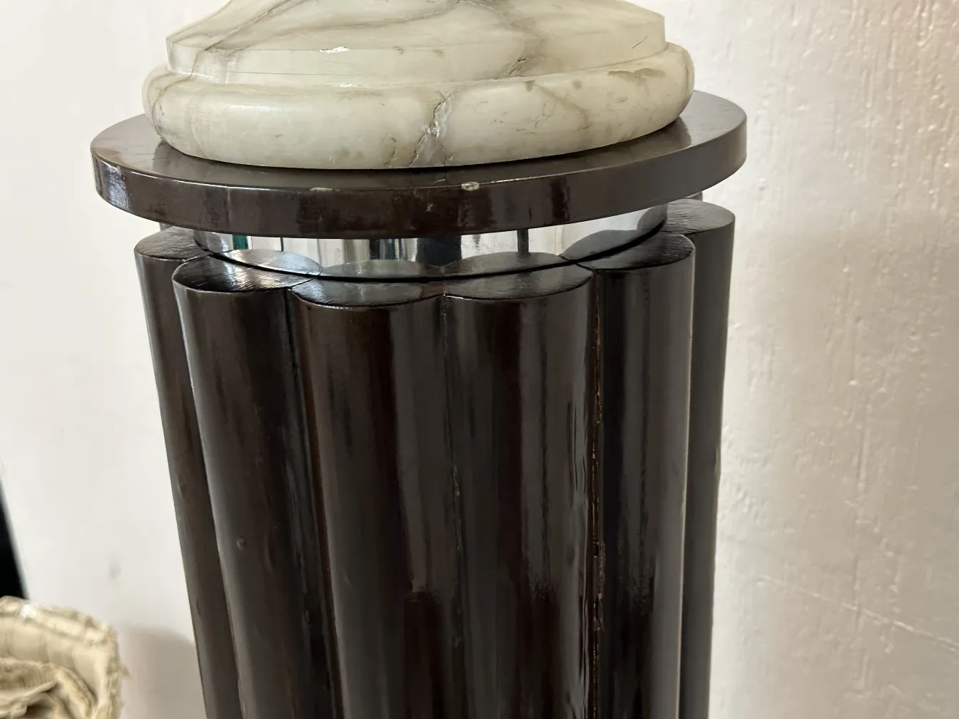 Lampadaire ancien avec base élégante et détails décoratifs, dans un cadre accueillant.