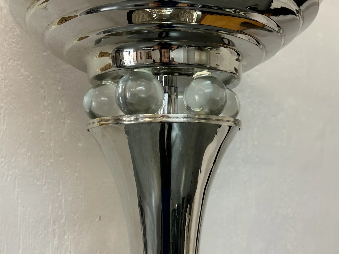 close-up of 2 antique floor lamps with shiny features in a cozy setting