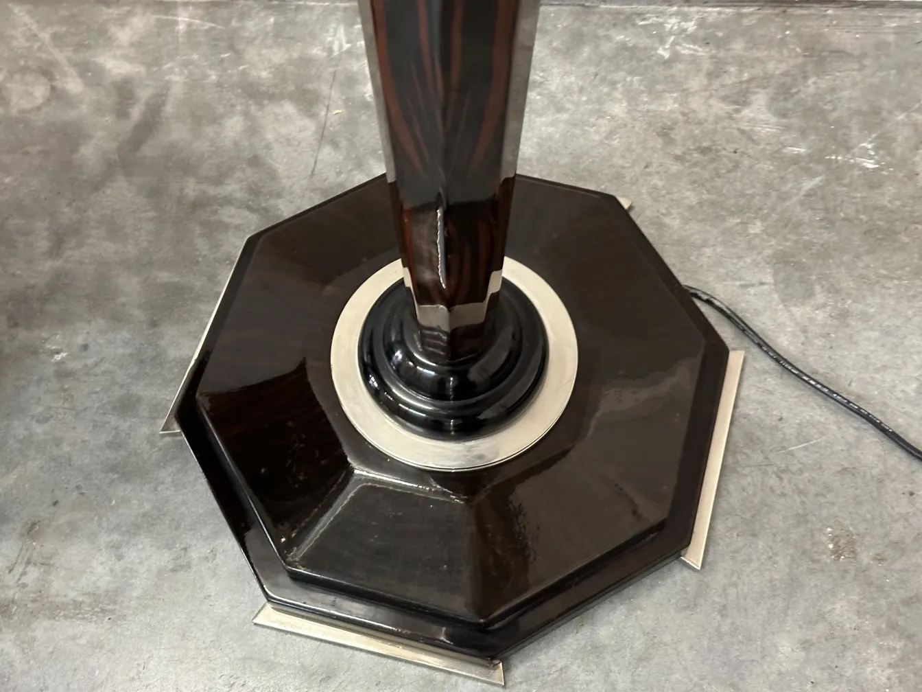 View of the octagonal base of two antique floor lamps with an elegant design.