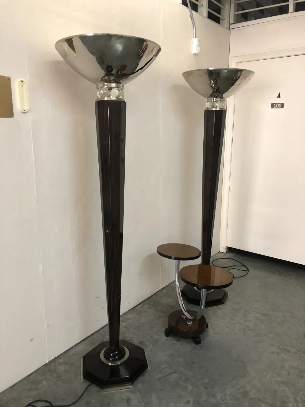Image of two antique floor lamps with bright light in a neutral setting