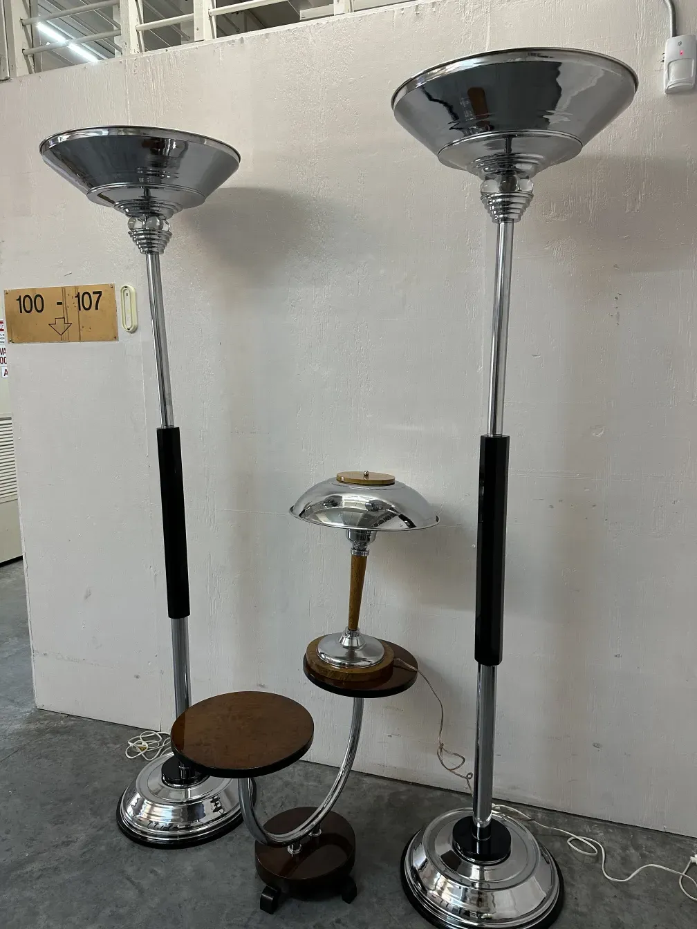 two antique floor lamps with round bases and elegant shades
