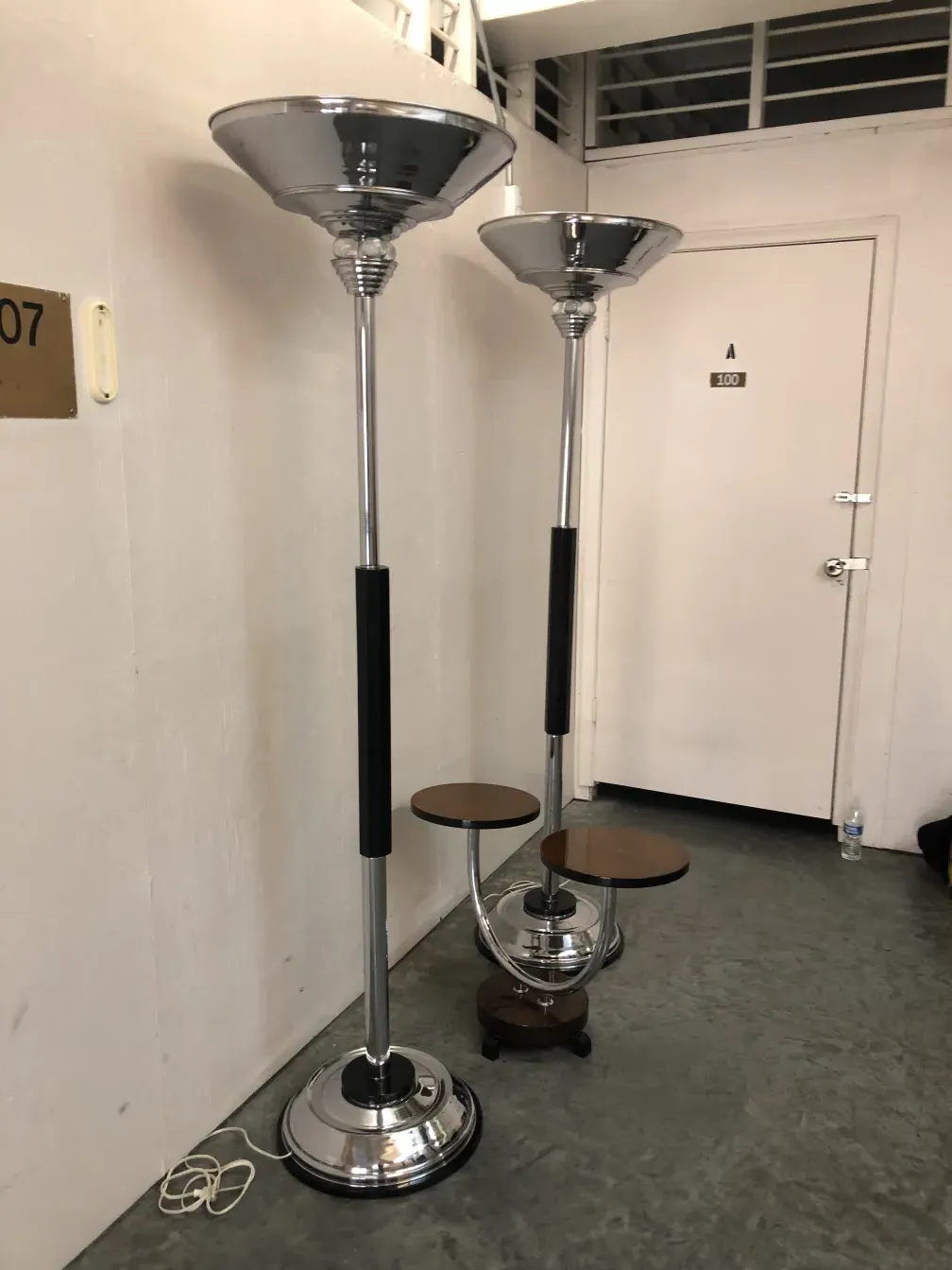 Two antique floor lamps featuring stylish designs and chrome bases.
