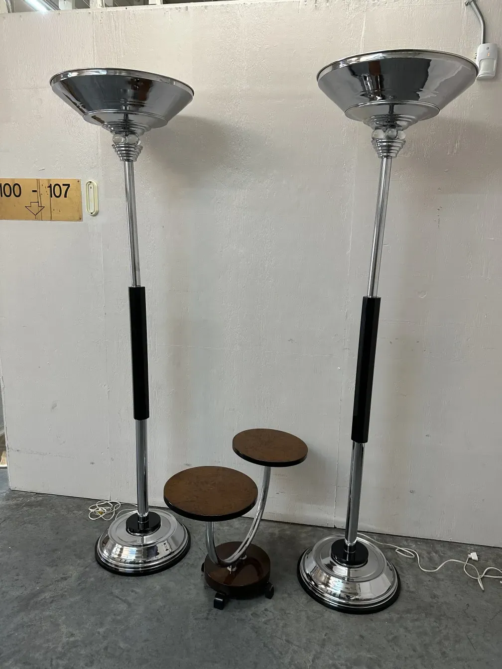 Set of 2 antique floor lamps with silver shades and shiny bases.