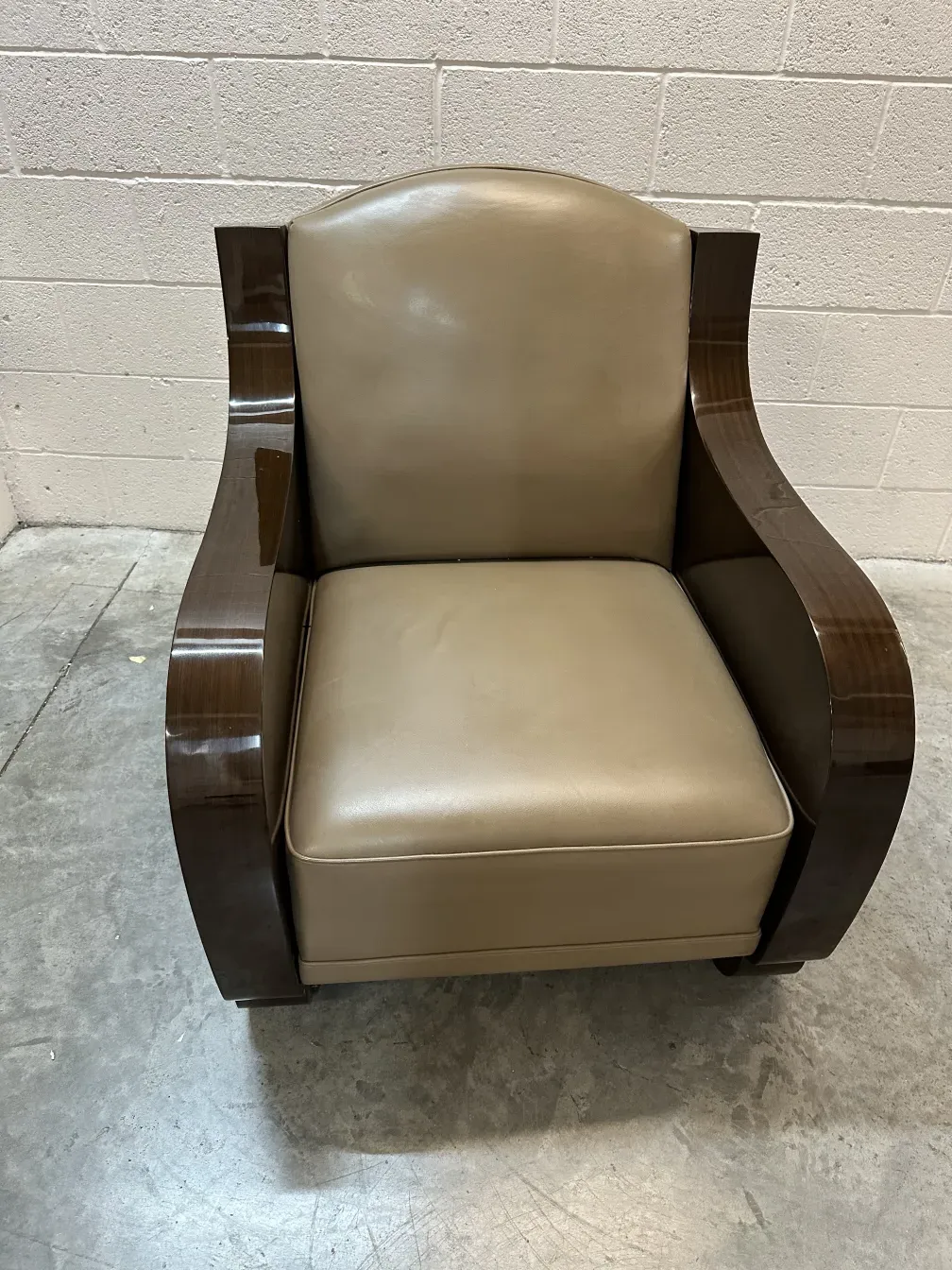 A pair of antique armchairs with elegant curves in a neutral setting