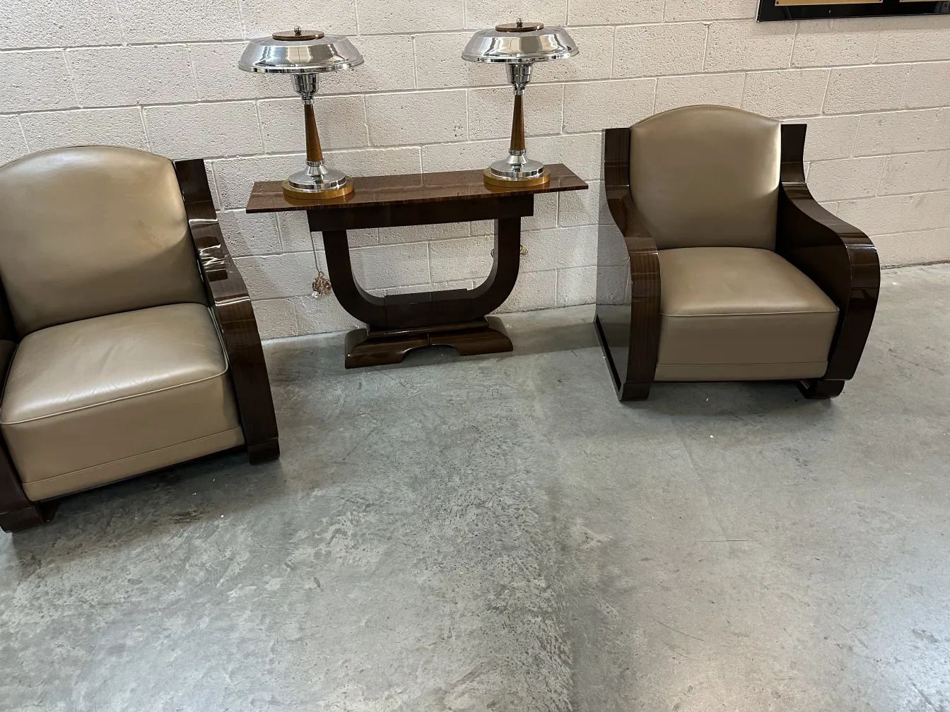 2 antique armchairs with light upholstery next to a table