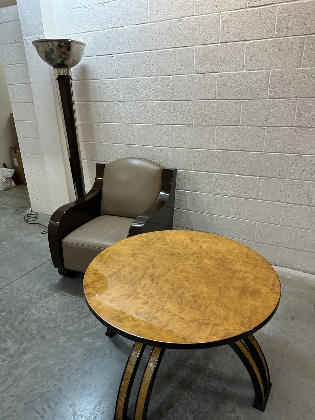 Antique coffee table with a round top and elegant legs in a modern setting.